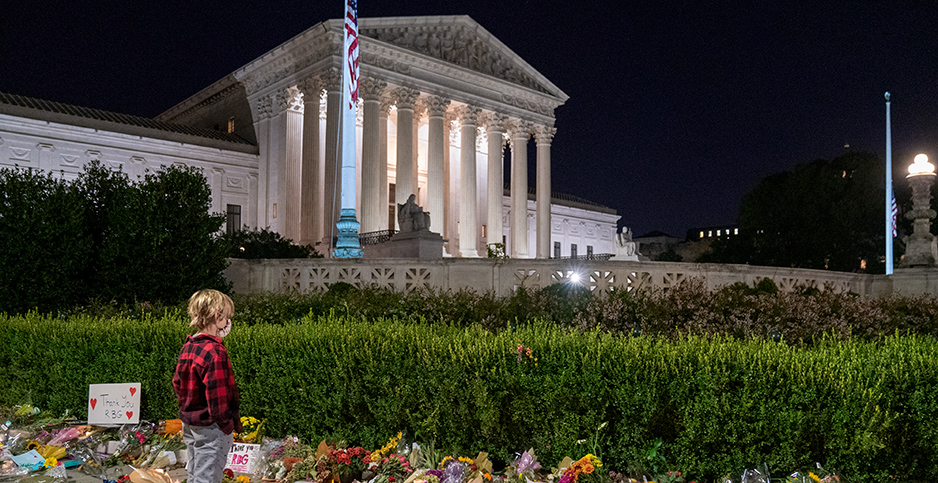 Miles Flynn, 10, views the thousands of flowers and trinkets left near the steps of the Supreme Court as mourners pay their respects for Supreme Court Justice Ruth Bader Ginsburg. Photo credit: Ken Cedeno/UPI/Newscom 