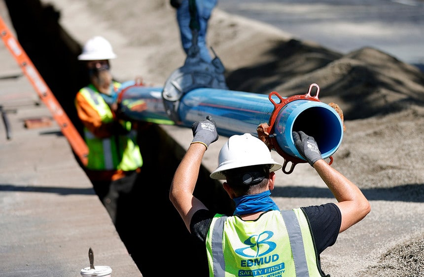 Workers with East Bay Municipal Utility District install a new water pipe in April in Walnut Creek, Calif.