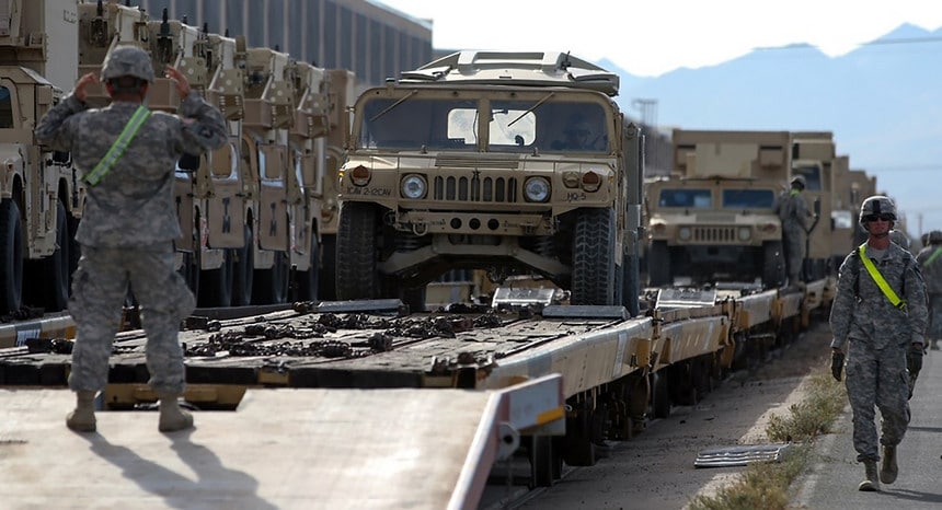 Tactical vehicles are unloaded from rail cars in the Yermo Annex of Marine Corps Logistics Base Barstow