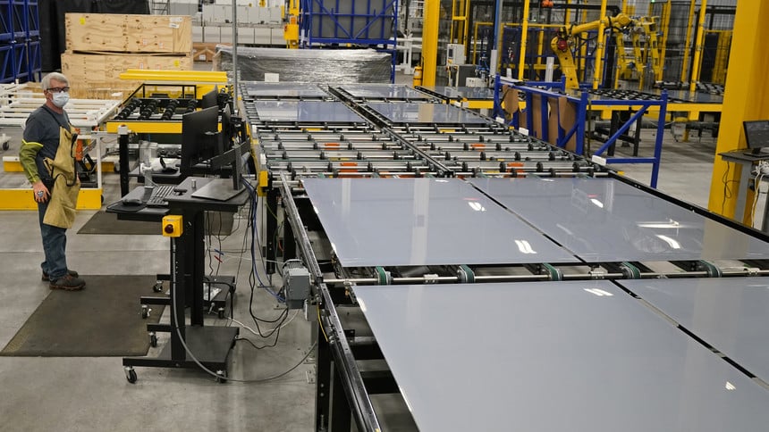 Machine operator Chuck Smith watches as solar panels are manufactured on the assembly line at the First Solar manufacturing plant, Wednesday, Oct. 6, 2021, in Walbridge, Ohio. First Solar is a leading global provider of comprehensive PV solar systems using advanced module and system technology.